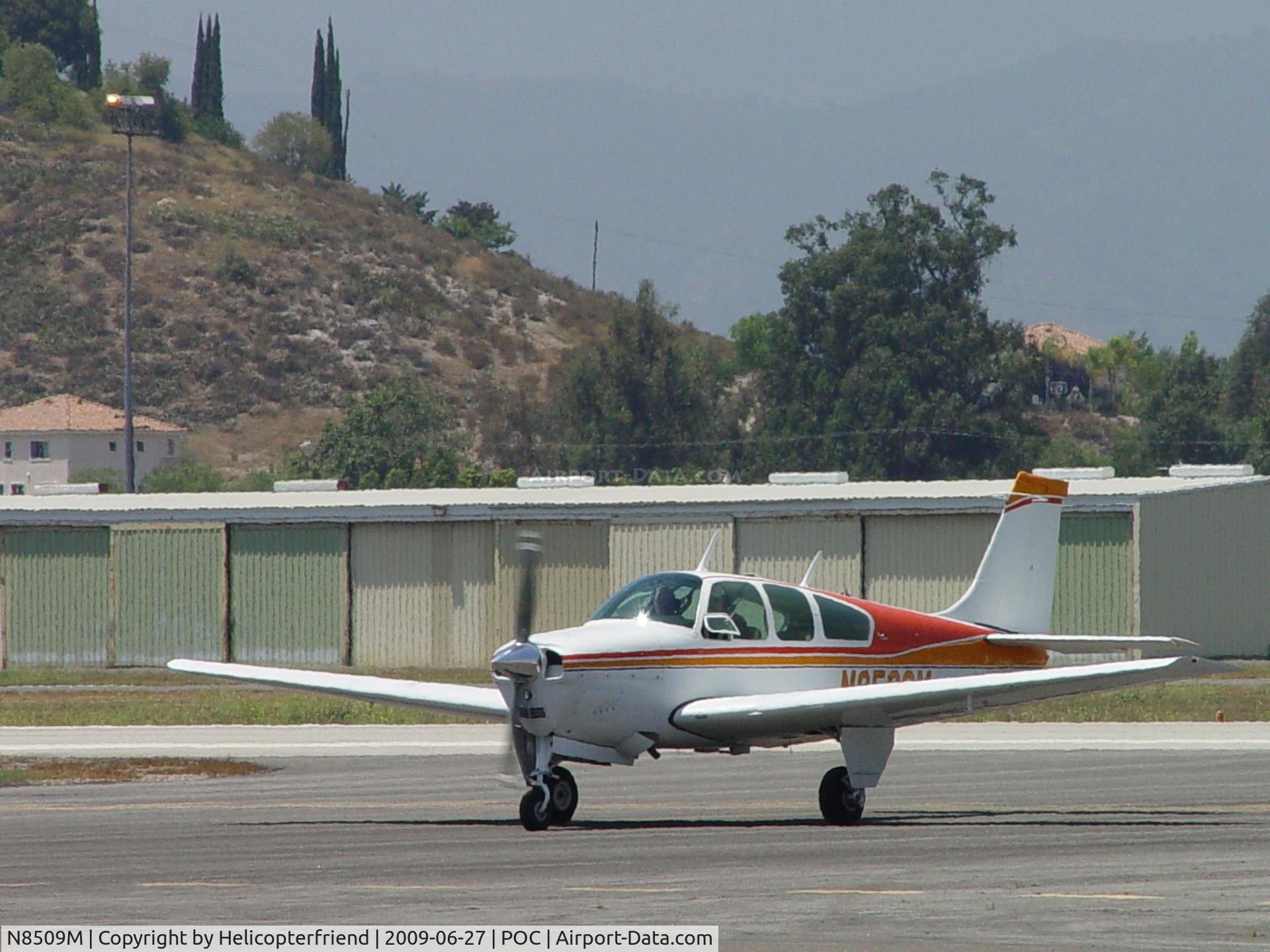N8509M, 1963 Beech 35-B33 Debonair C/N CD-626, Waiting to cross active runway 26L