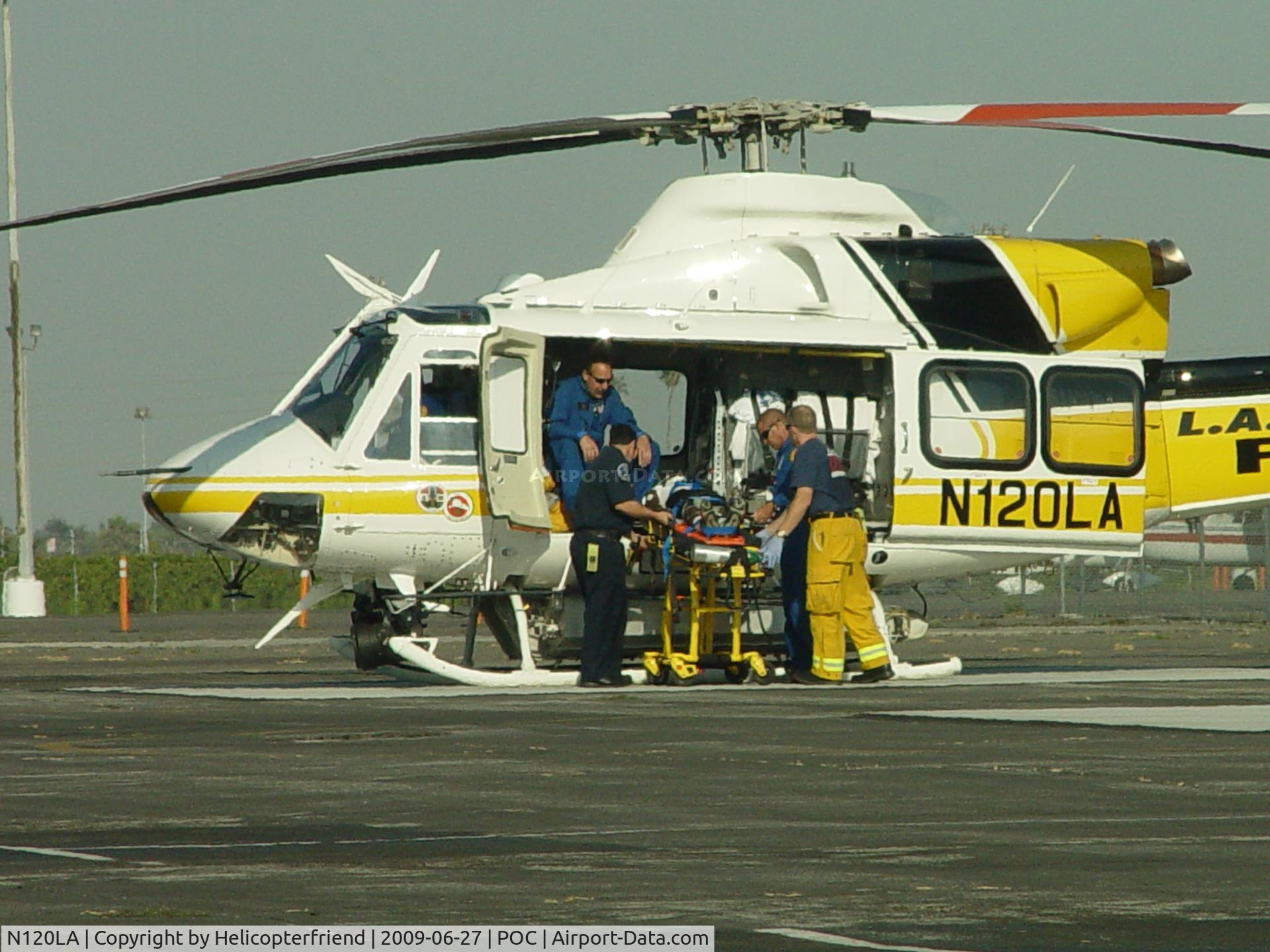 N120LA, 2007 Bell 412EP C/N 36455, Patient being placed on board for transportation