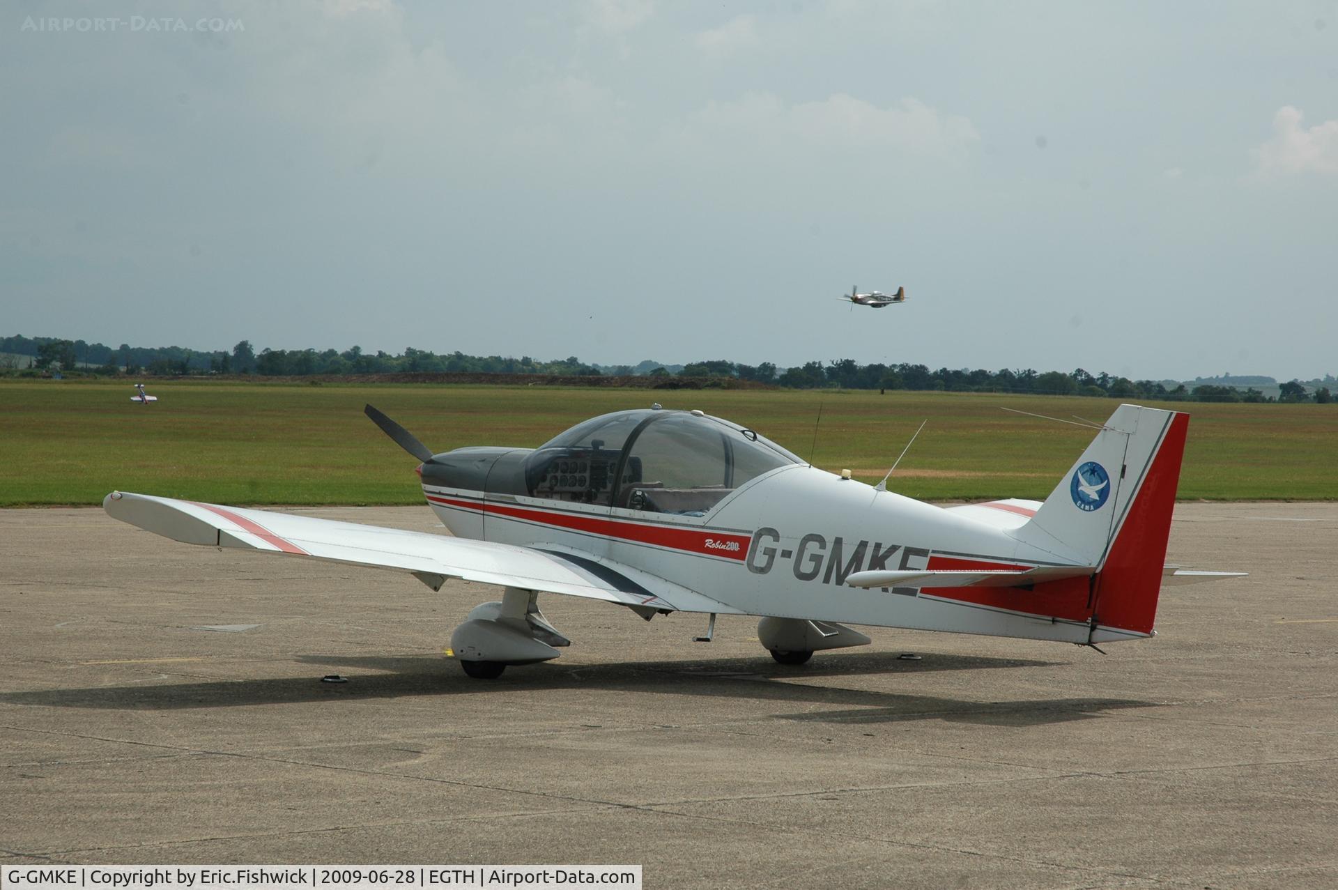 G-GMKE, 1993 Robin HR-200-120B C/N 257, G-GMKE at Duxford with Mustang 'Miss Velma' in the background - (I'ts o.k. - the plane on the grass is a scale model !)