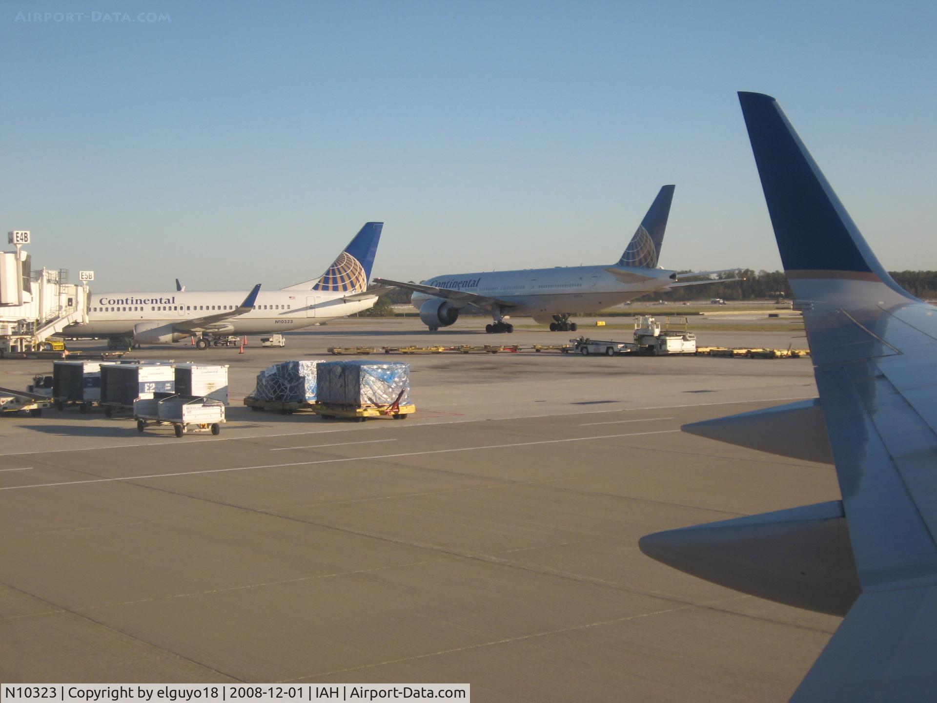 N10323, 1986 Boeing 737-3TO C/N 23374, 737-300 BESIDE A 777-200 LR