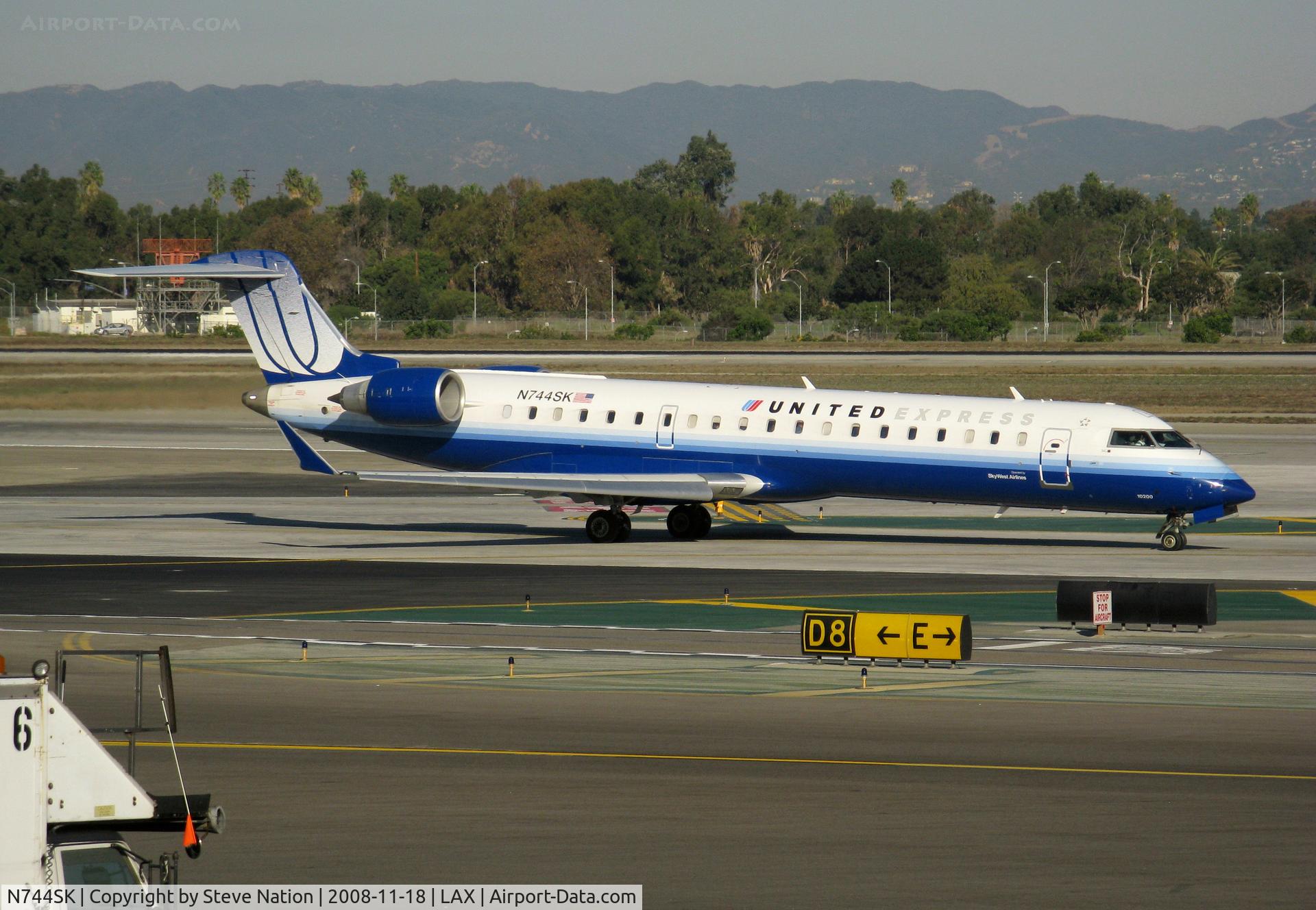 N744SK, 2005 Bombardier CRJ-701 (CL-600-2C10) Regional Jet C/N 10200, United Express 2005 Bombardier CL-600-2C10 in latest colors (small Sky West Airlines titles) taxiing to RW 24L