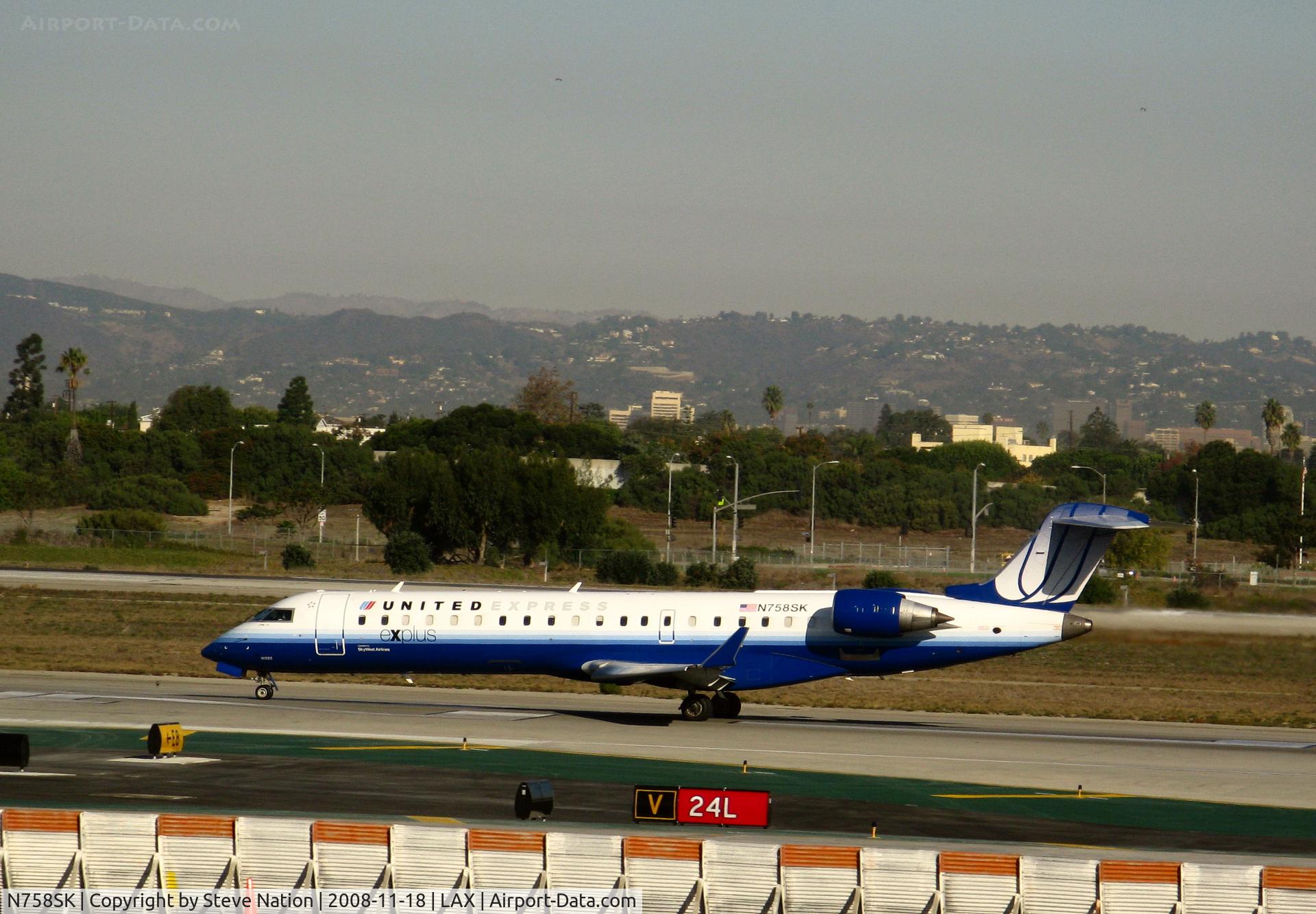 N758SK, 2005 Bombardier CRJ-701ER (CL-600-2C10) Regional Jet C/N 10222, United Express 'Explus' 2005 Bombardier CL-600-2C10 in latest colors rolling on RW 24L