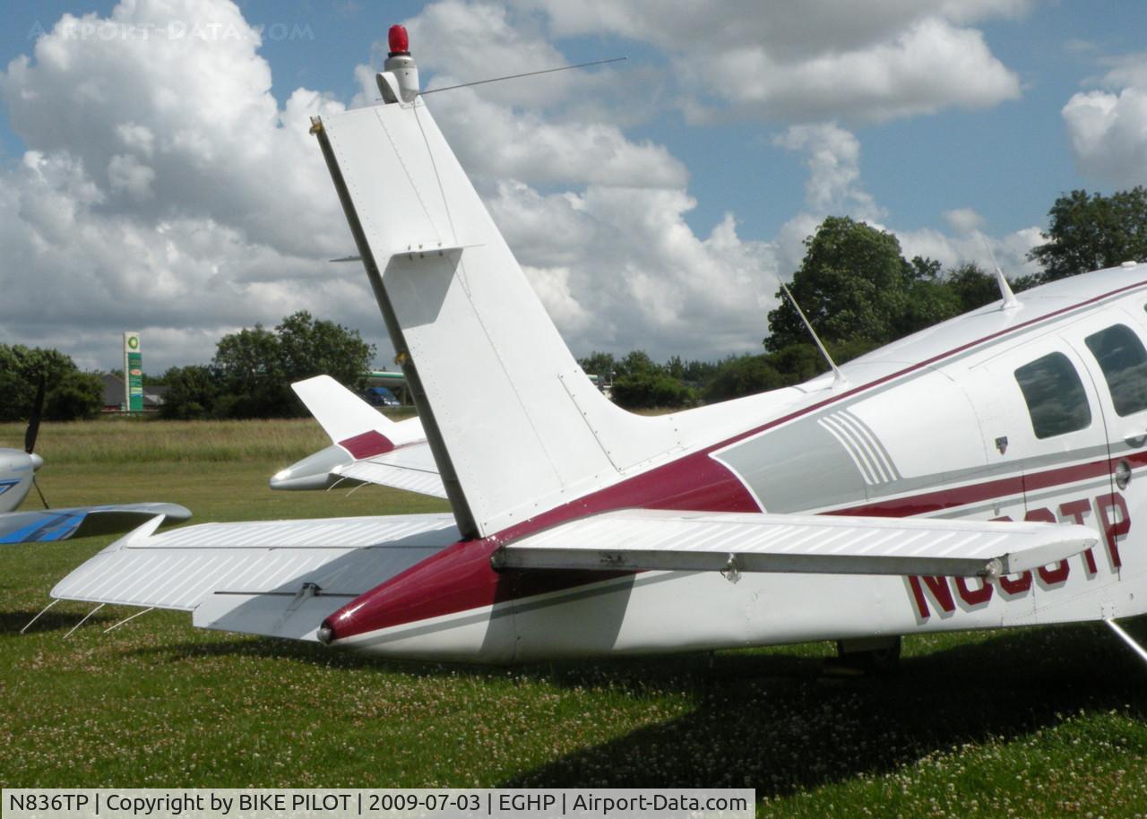 N836TP, 1984 Beech A36 Bonanza 36 C/N E=2124, CONTROL SURFACES DAMAGED AFTER A/C ROLLED BACKWARDS DOWN A SLOPE INTO A WOODEN SHED OVER NIGHT, A/C REPAIRABLE SHED W/O.