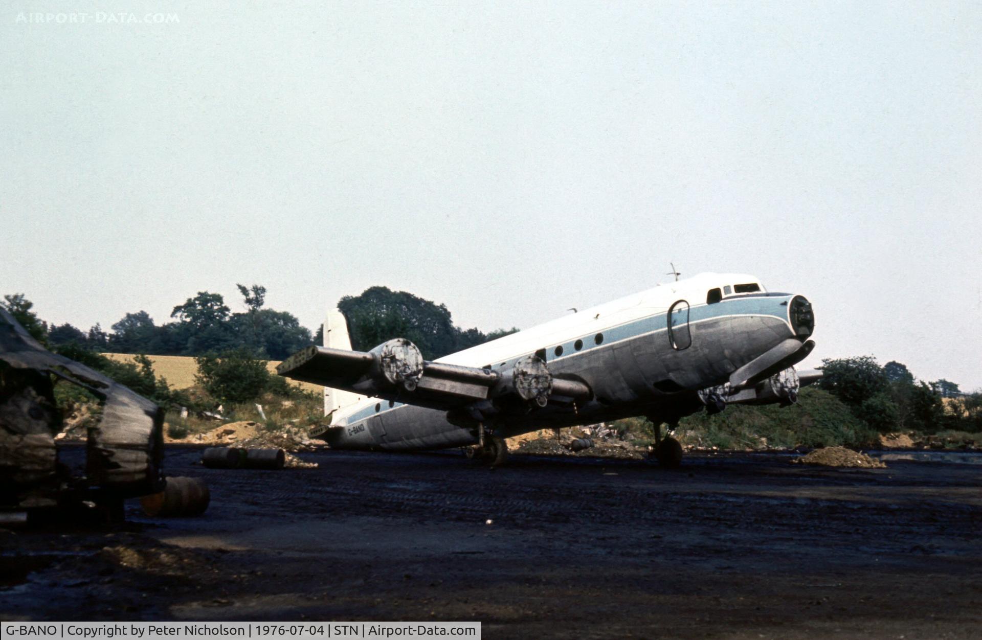 G-BANO, 1946 Douglas DC-4 Skymaster C/N 42988, DC-4 seen in the Civil Aviation Authority's Fire Training School at Stansted in the Summer of 1976.