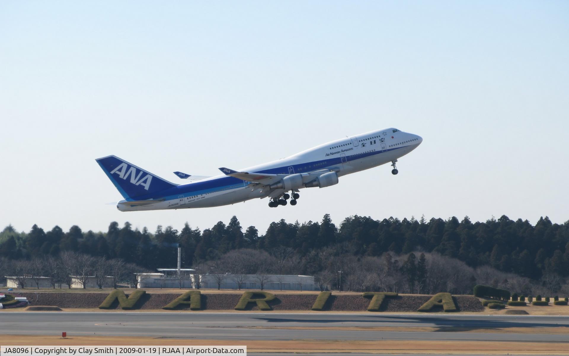 JA8096, 1990 Boeing 747-481 C/N 24920, ANA flight taking off in front of the Narita sign.