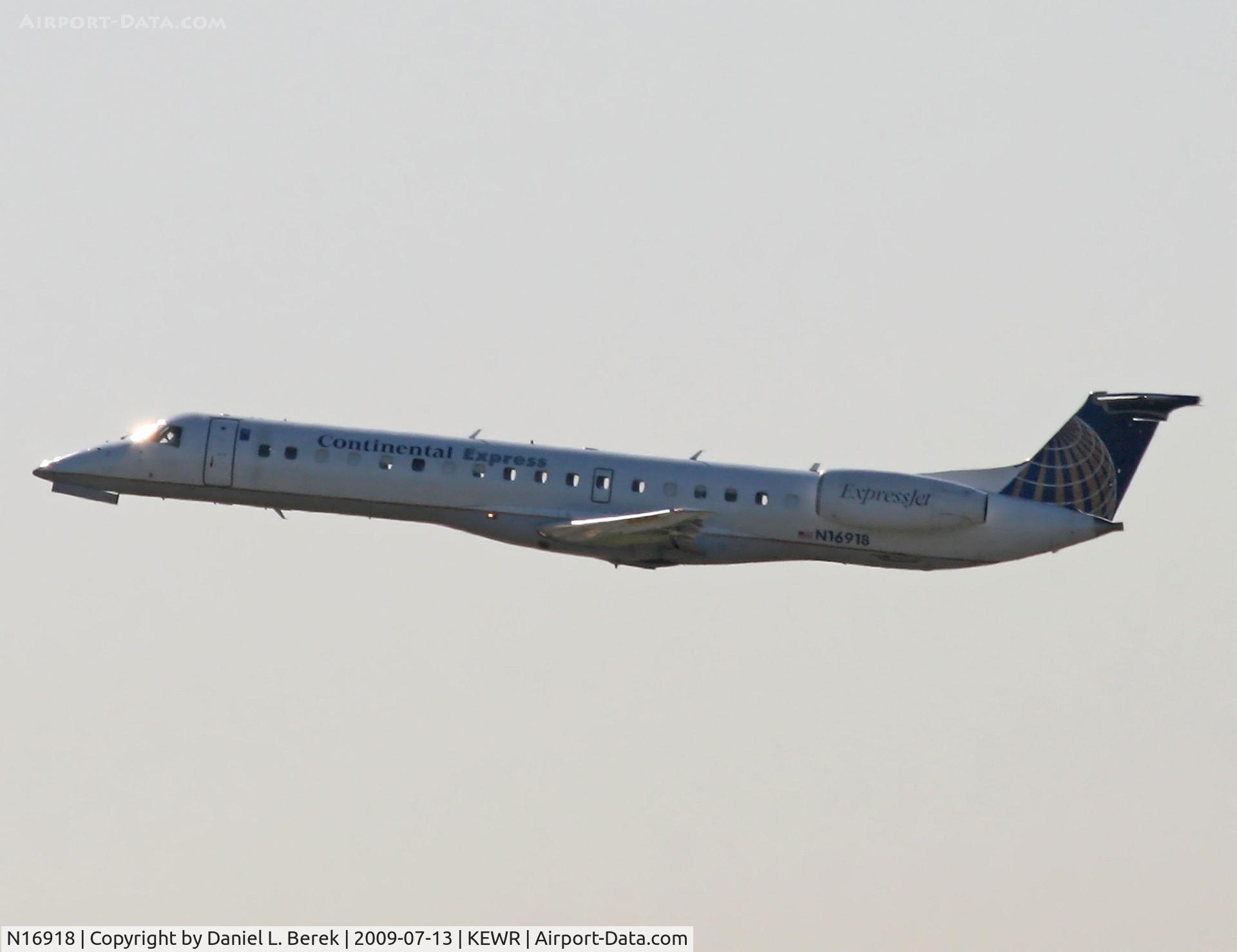 N16918, 2001 Embraer ERJ-145LR (EMB-145LR) C/N 145397, A Continental Express regional jet launches into the early morning sunshine at Newark.