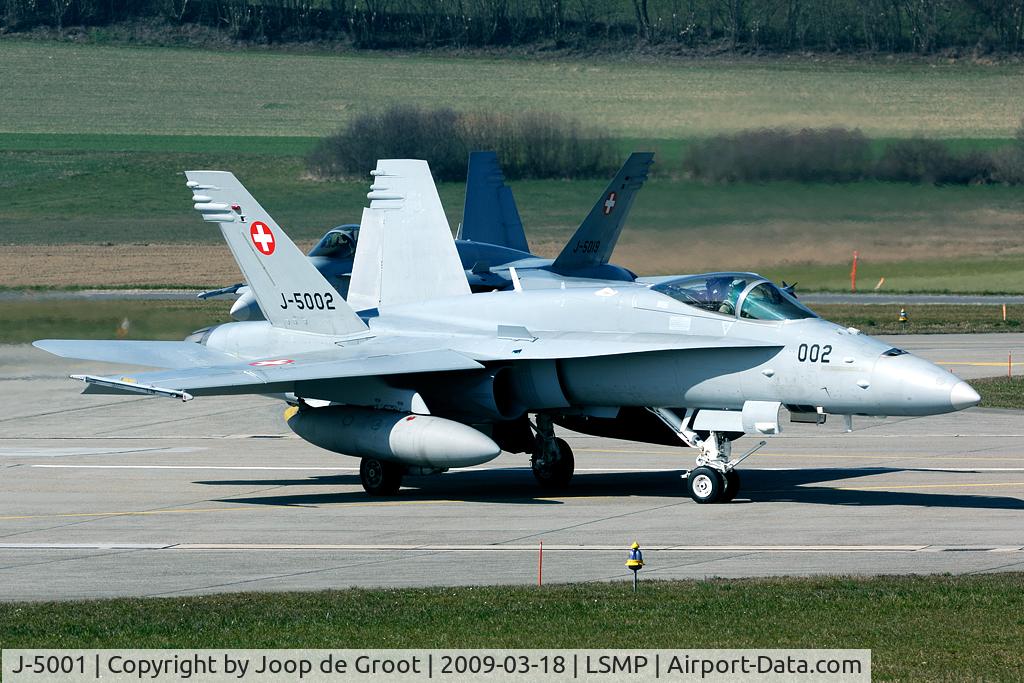 J-5001, 1996 McDonnell Douglas F/A-18C Hornet C/N 1316/SFC001, J-5002 is turning onto the runway; J-5019 rolling behind.