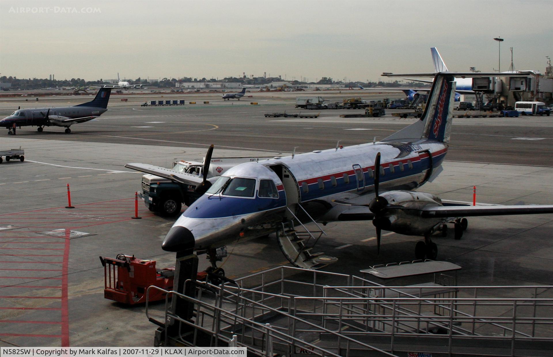 N582SW, 1999 Embraer EMB-120ER Brasilia C/N 120350, SkyWest Embraer EMB-120ER, N582SW at the gate KLAX -note the A380 test plane in the far background.