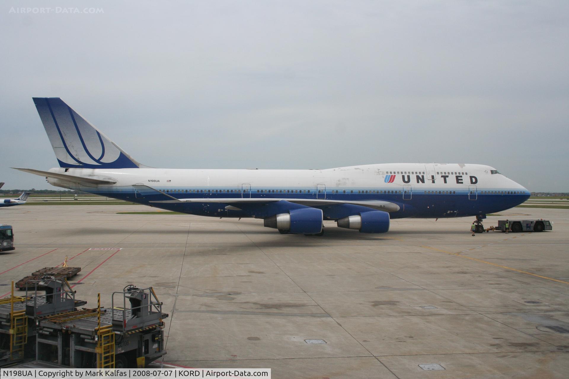 N198UA, 1997 Boeing 747-422 C/N 28716, United Airlines Boeing 747-422, N198UA at KORD pushing back C18 for a trip to ZBAA.