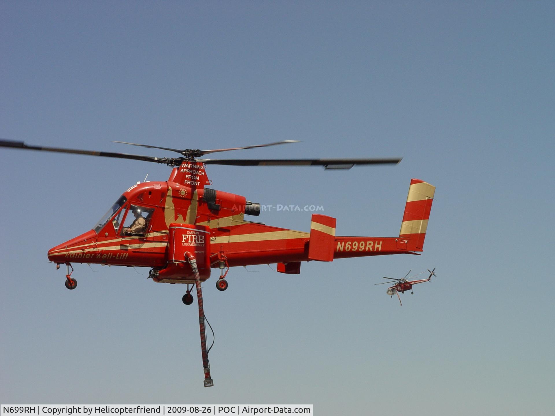 N699RH, 1994 Kaman K-1200 K-Max C/N A94-0019, Awaiting instructions as N792HT passes behind heading out