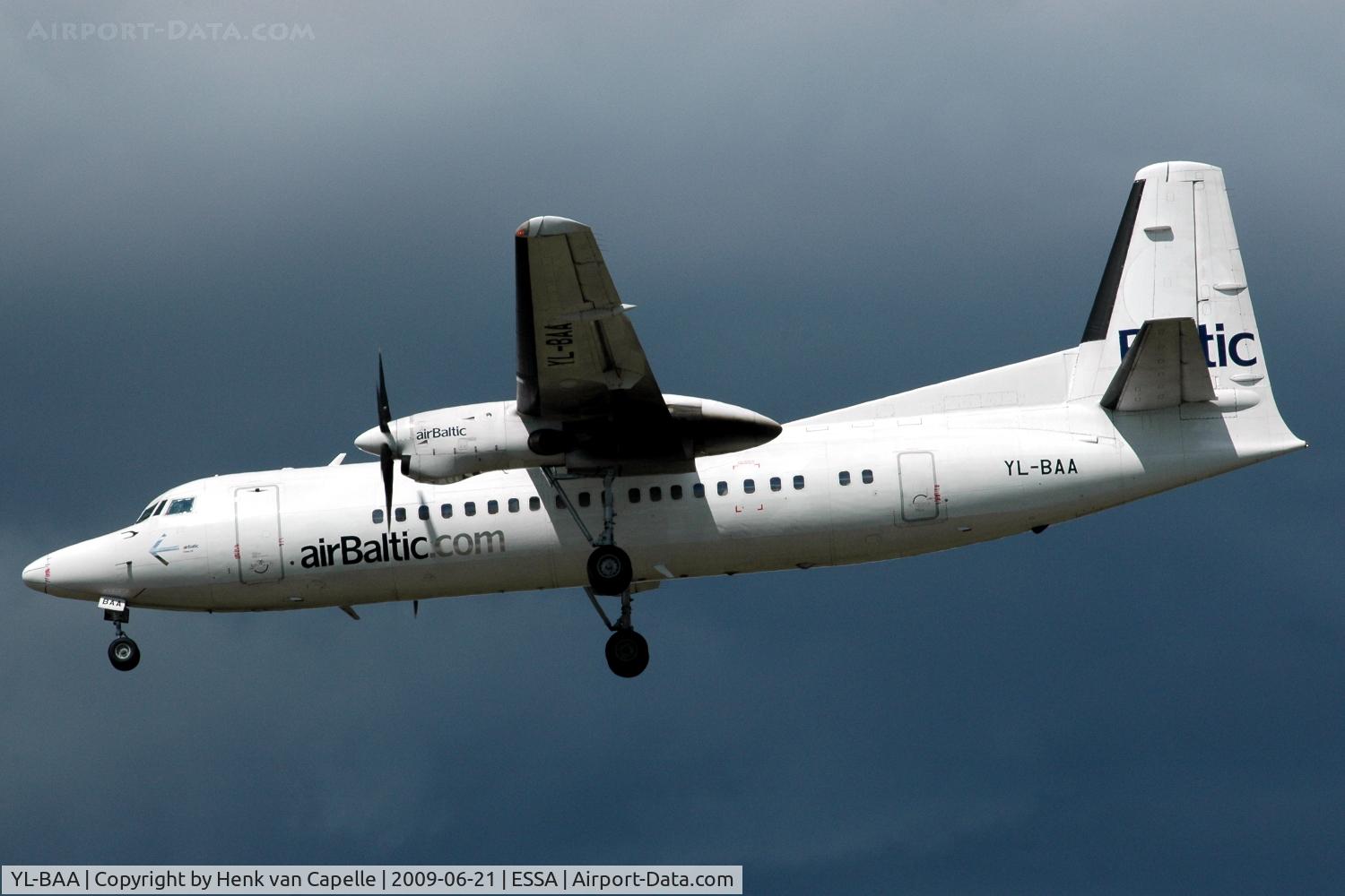 YL-BAA, 1988 Fokker 50 C/N 20120, A white Air Baltic Fokker 50 in front of a dark cloud about to land at Stockholm Arlanda. Note the bad paintwork.