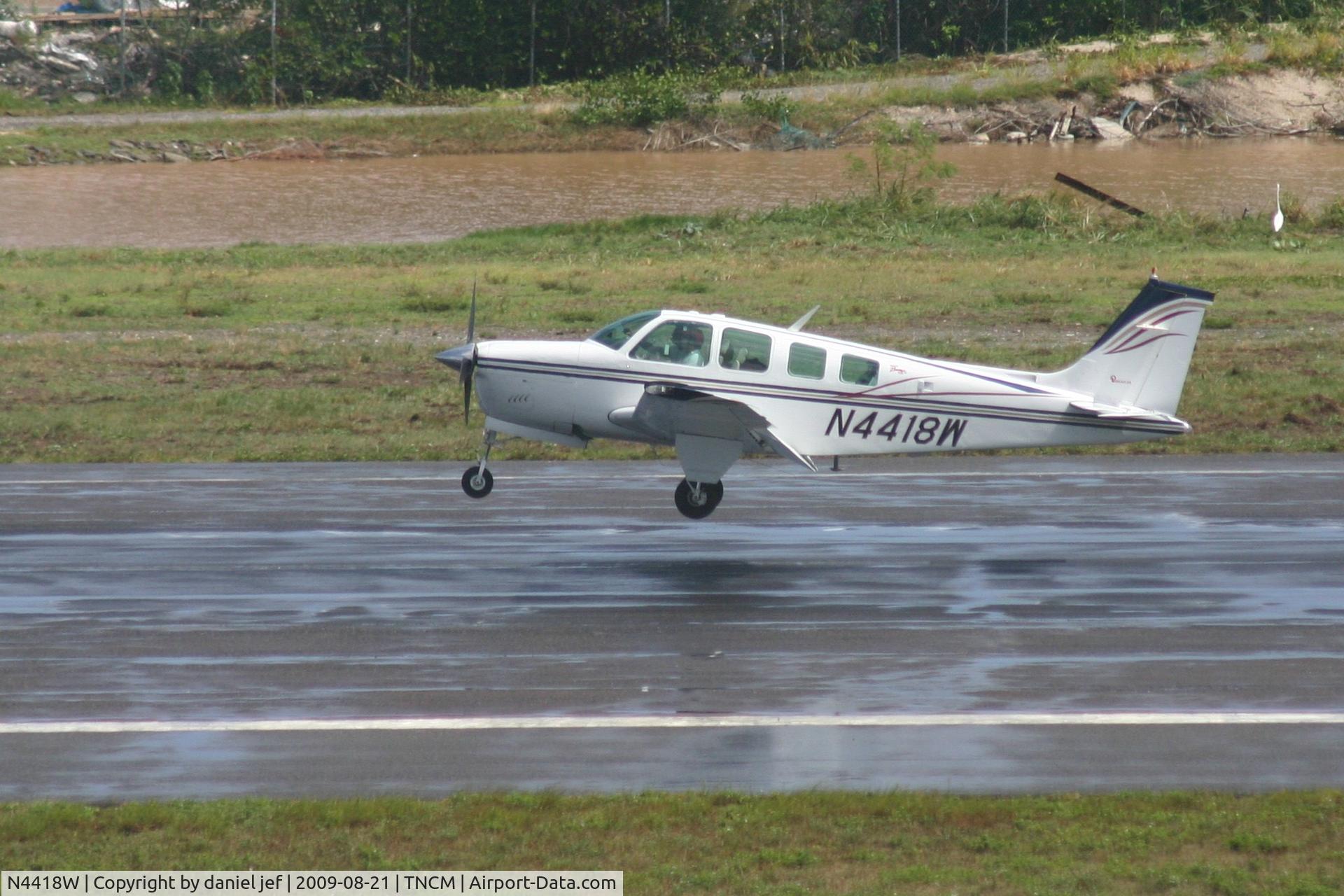 N4418W, 1974 Beech A36 Bonanza 36 C/N E-527, landing on a wet runway