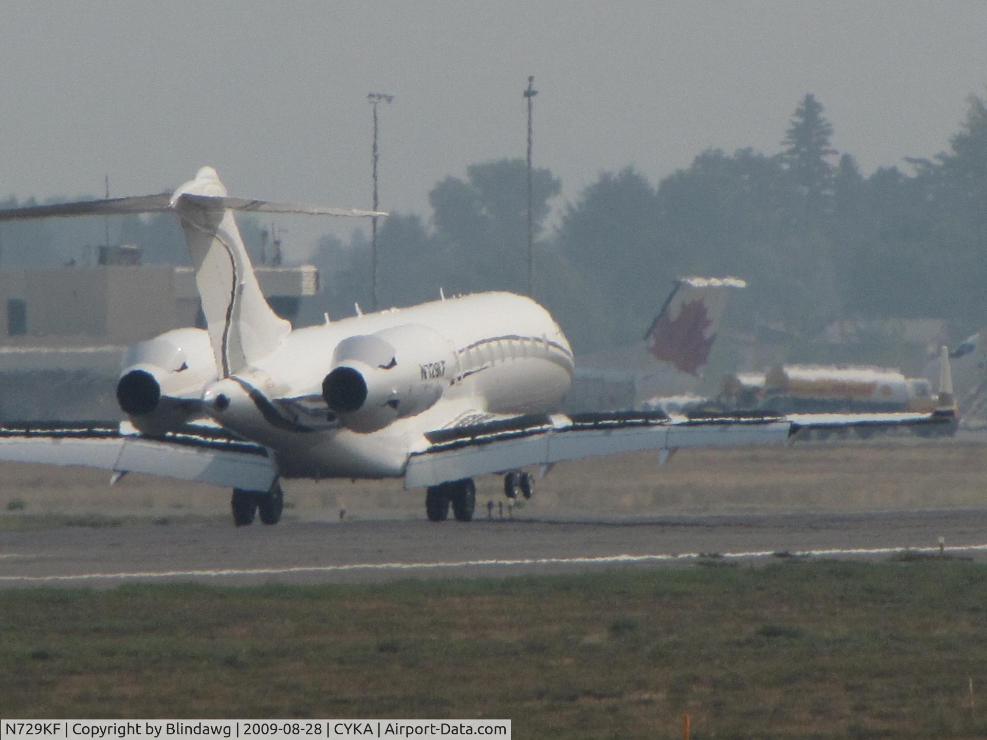N729KF, 2005 Bombardier BD-700-1A11 Global 5000 C/N 9172, shot of the spoilers and flaps...heat haze as the temp is near 100 fah