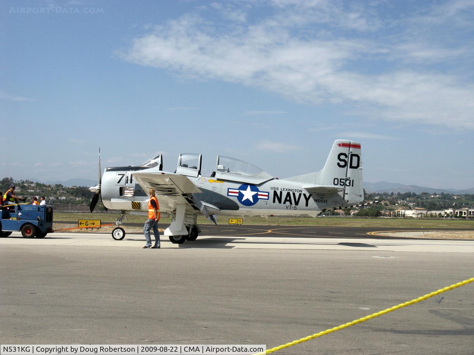 N531KG, 1954 North American T-28C Trojan Trojan C/N 226-108, 1954 North American T-28C TROJAN 'Tough Old Bird', Wright R-1820-86 Cyclone 1,425 Hp, under tow with wing walker