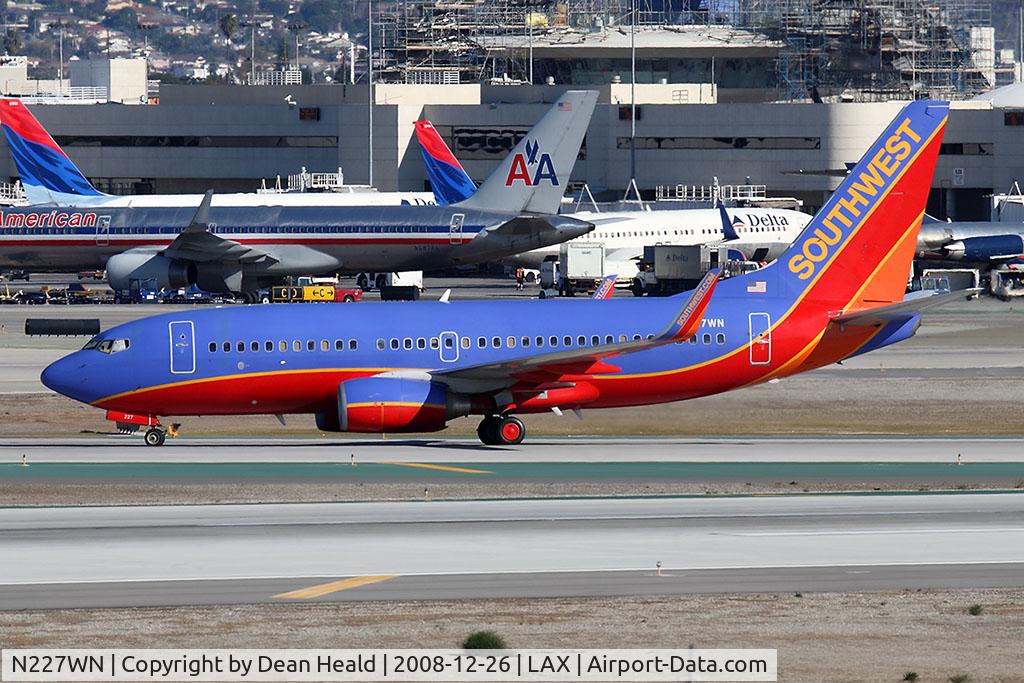 N227WN, 2005 Boeing 737-7H4 C/N 34450, Southwest Airlines N227WN holding short of RWY 25R after arrival on 25L.