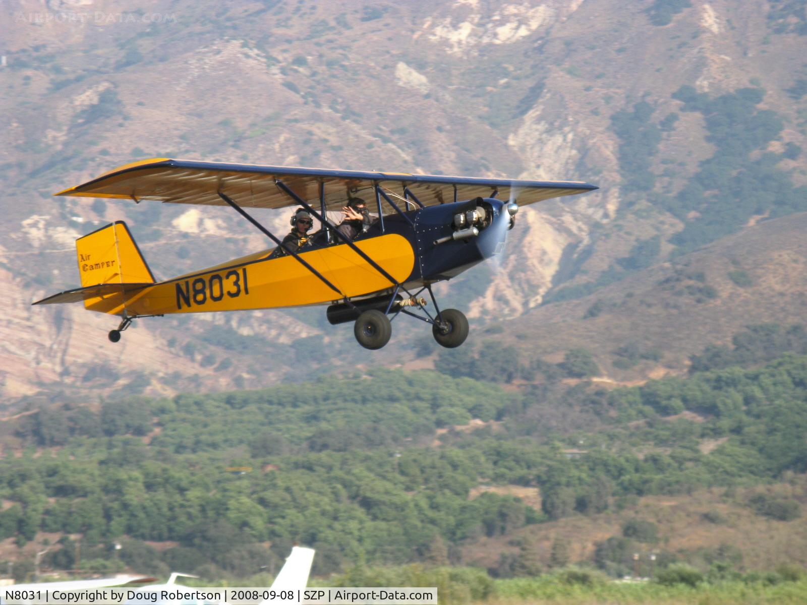N8031, 1979 Pietenpol Air Camper C/N PHM1, 1979 Heglie PIETENPOL AIR CAMPER, Continenta A&C A65 65 Hp, no electrical system parasol wing early homebuilt design. takeoff climb Rwy 22 and wave to photographer.
