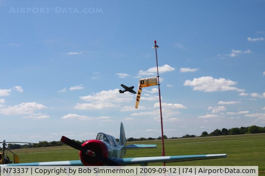 N73337, 1951 North American T-6G Texan C/N 168-451, Departing the MERFI fly-in, Urbana, Ohio.  N21CY in the foreground.