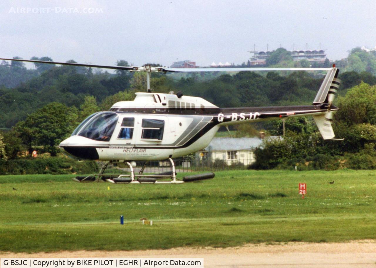 G-BSJC, 1982 Bell 206B JetRanger III C/N 3689, JETC HELICOPTERS JET RANGER WITH GOODWOOD RACE COURSE GRANDSTAND IN THE DISTANCE, 1990. LATER REG. G-BVRC, G-SPYI, TO SEYCHELLES JUNE 2006 