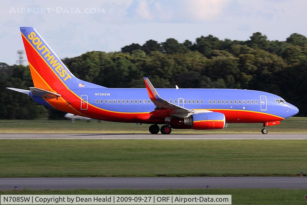 N708SW, 1998 Boeing 737-7H4 C/N 27842, Southwest Airlines N708SW (FLT SWA1129) starting takeoff roll on RWY 23 enroute to Chicago Midway Int'l (KMDW). Seen here in the bright sun, but shadows all around. The clouds were passing across the sky.