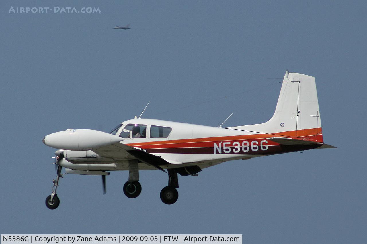N5386G, 1958 Cessna U-3A Blue Canoe (310A) C/N 38133, Landing at Meacham Field, Forth Worth - notice the USAF F-16 on a down wind at NAS Fort Worth in the back ground!