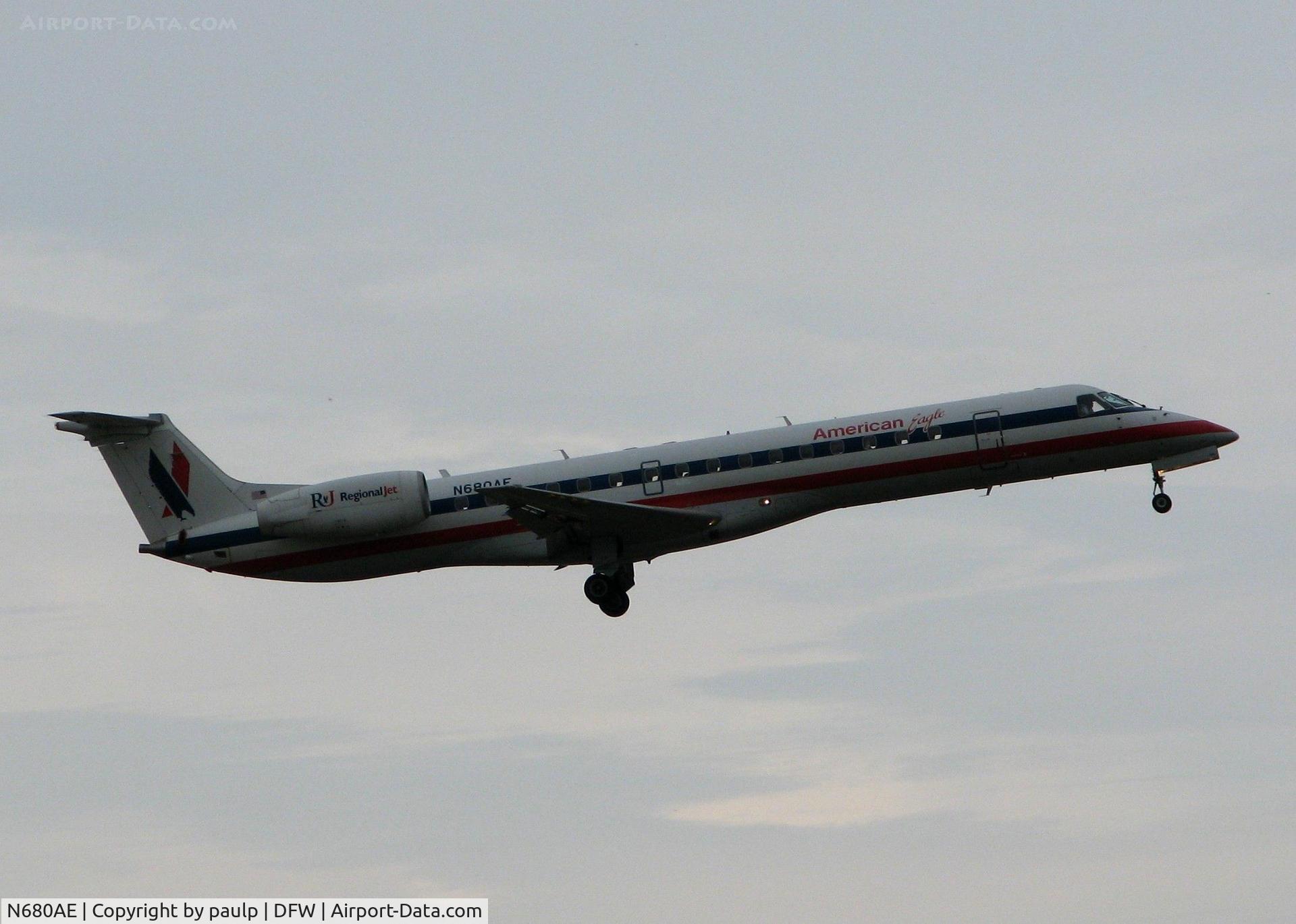 N680AE, 2004 Embraer ERJ-145LR (EMB-145LR) C/N 14500820, Landing on 18R at DFW. Nasty overcast, rainy day!