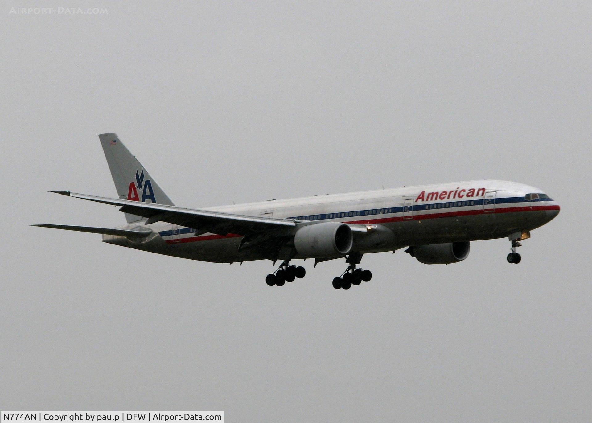 N774AN, 1999 Boeing 777-223 C/N 29581, Pouring down rain while landing on 18R at DFW. If you look close, it is pouring down!