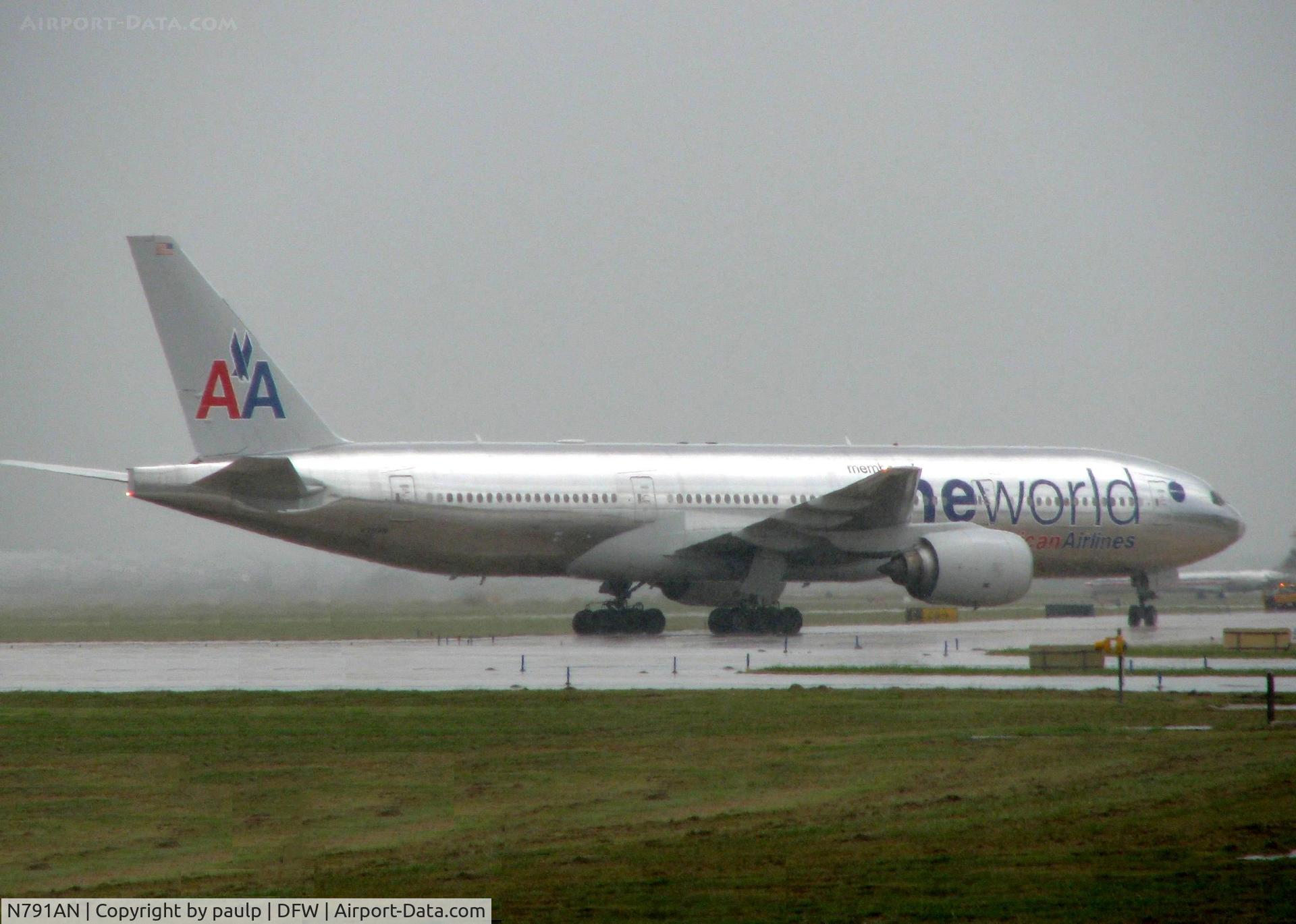 N791AN, 2000 Boeing 777-223/ER C/N 30254, Taxiing to the American Hanger after landing and unloading its passengers at the terminal. And a nasty day to be taking photos!