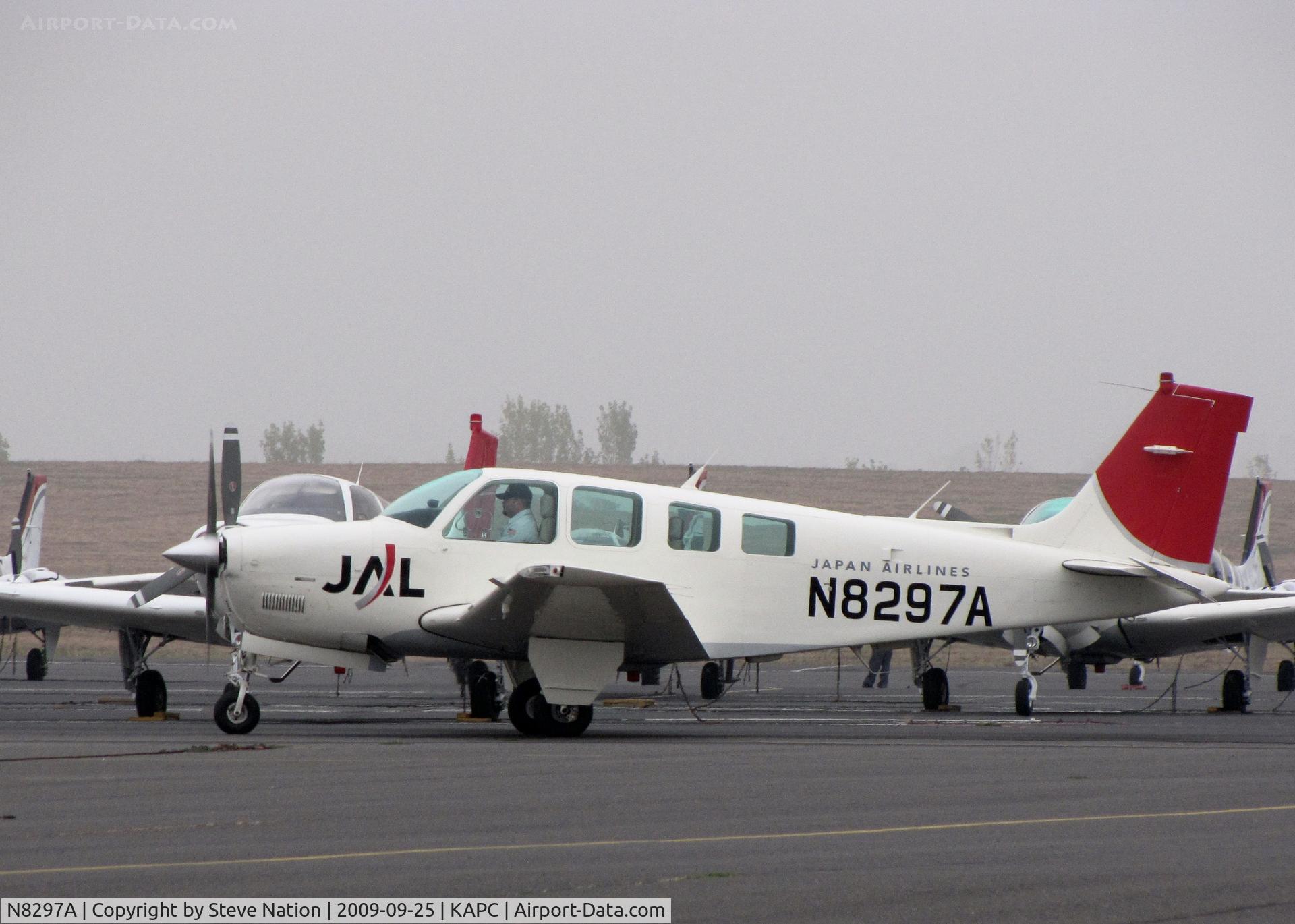 N8294M, 1992 Beech A36 Bonanza 36 C/N E-2761, Shown in latest colors - mechanic taxiing Japan Airlines 1992 Beech A36 for day's training flights- foggy morning at KAPC home base