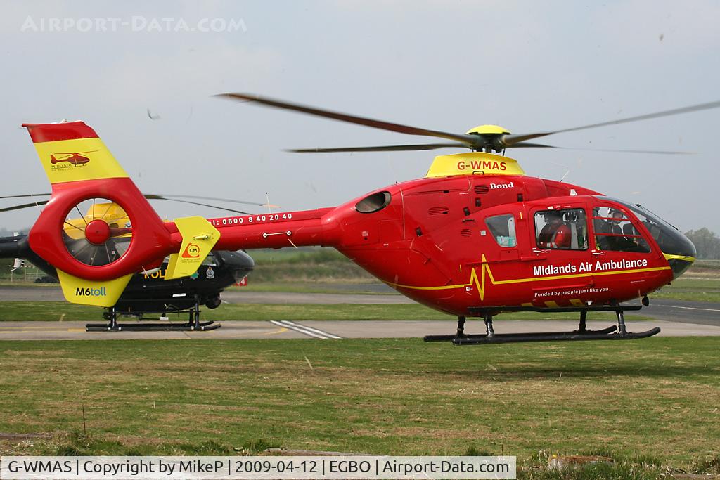 G-WMAS, 2001 Eurocopter EC-135T-2 C/N 0174, Taking off on a mission - freshly mown grass blowing everywhere.
