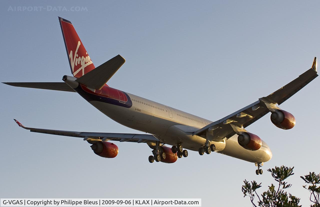 G-VGAS, 2005 Airbus A340-642 C/N 639, Diving to rwy 24R near sunset, passing over Sepulveda Boulevard and the 