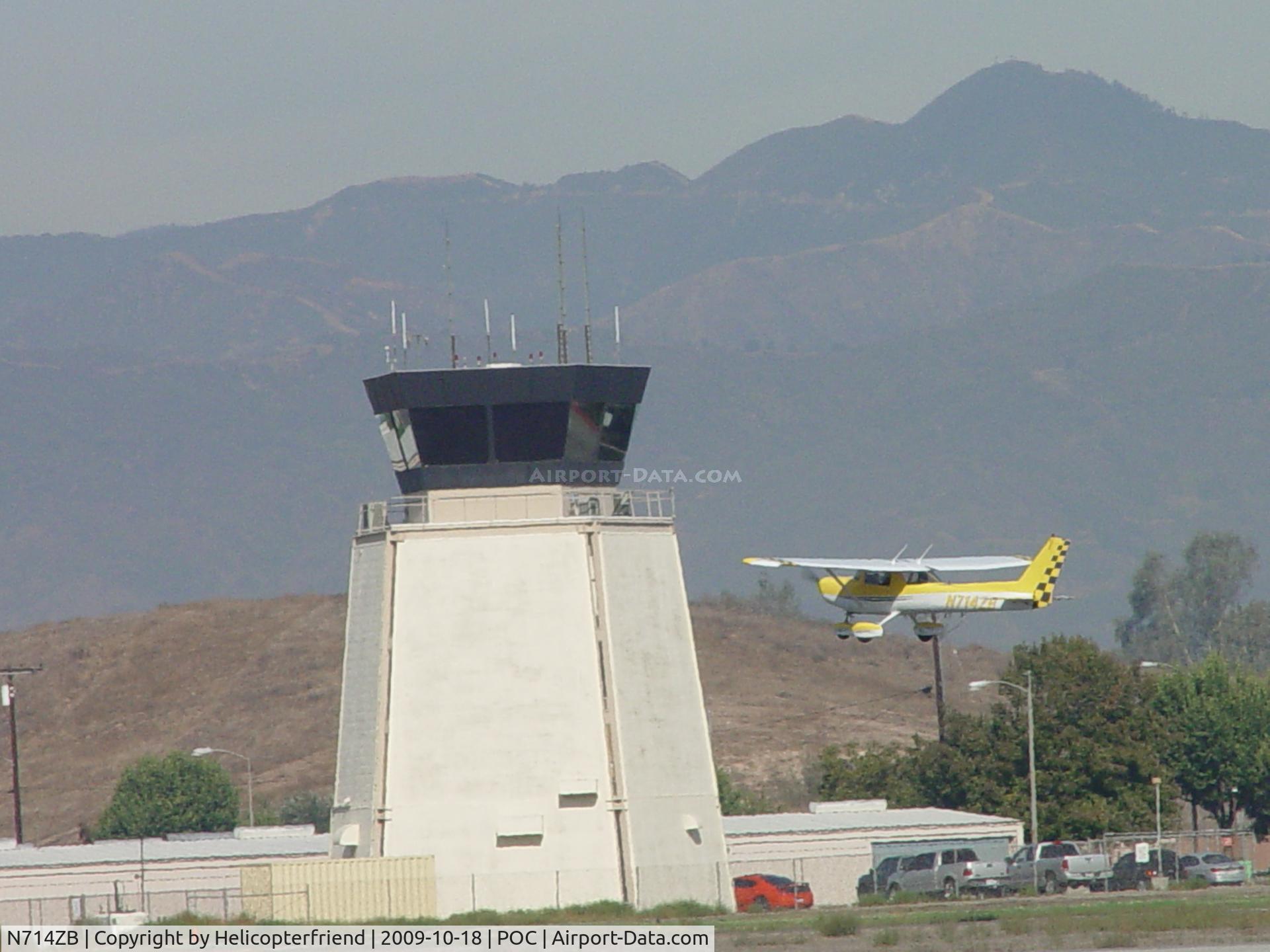 N714ZB, 1977 Cessna 152 C/N 15279552, Passing the tower westbound from 26R