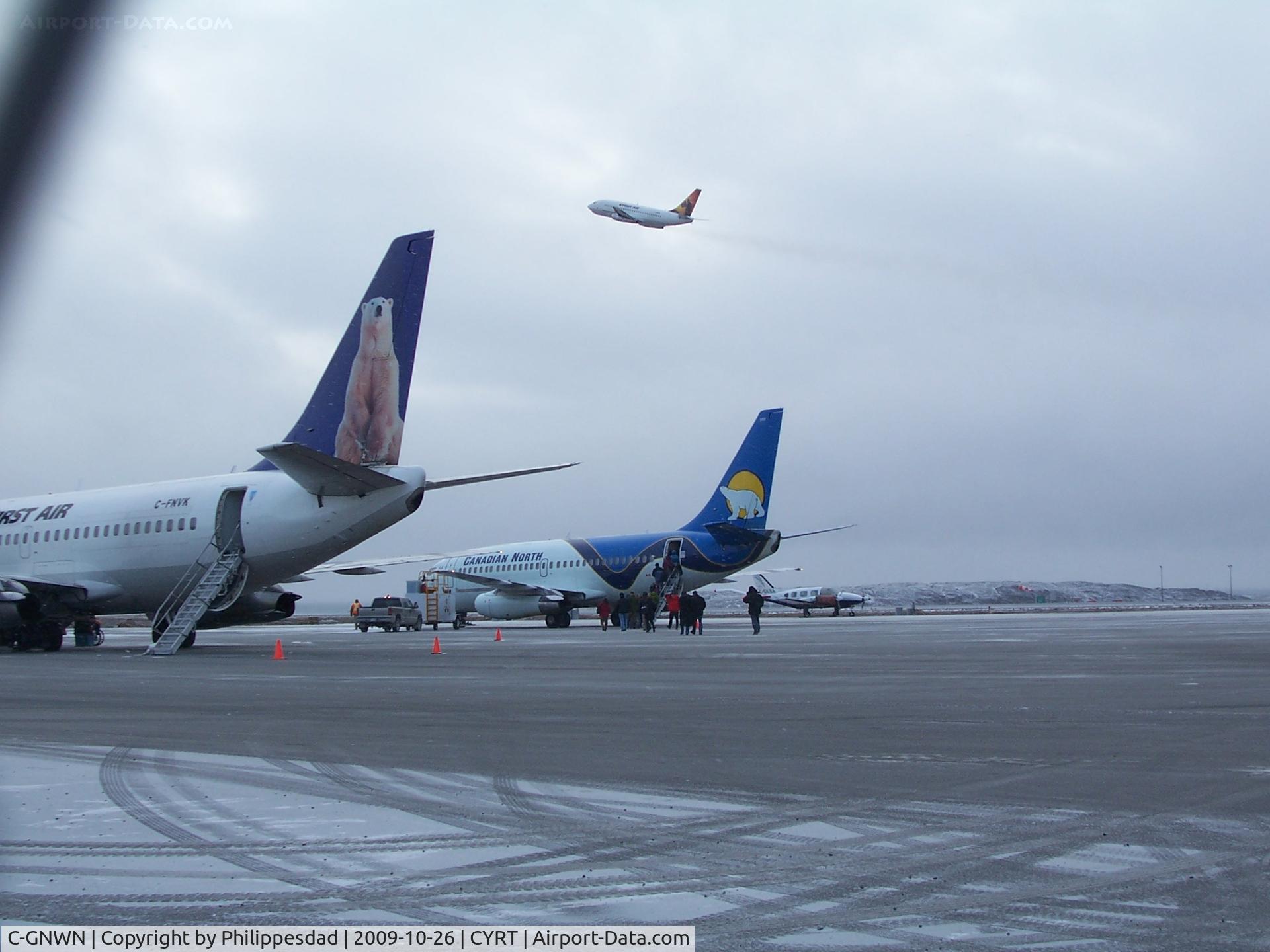 C-GNWN, Boeing 737-210C C/N 21067, C-GNWN taking off, Rankin Inlet, NU  2009oct26 with C-FNVK and unknown Canadian North 737 in foreground
