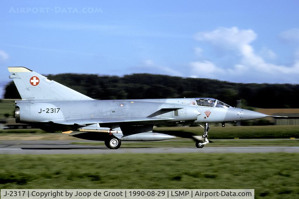 J-2317, Dassault (F+W Emmen) Mirage IIIS C/N 17-26-114/1007, Rushing down the taxiway in the early morning light. One of the first Mirage IIIS fitted with canards.