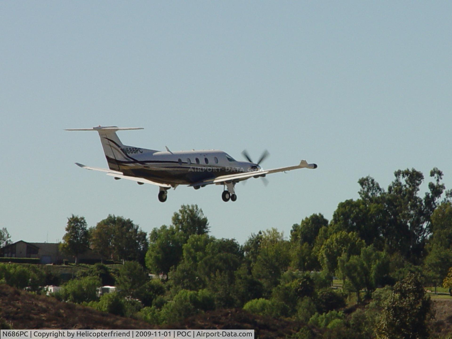 N686PC, 2005 Pilatus PC-12/47 C/N 686, Clearing the trees westbound from 26R