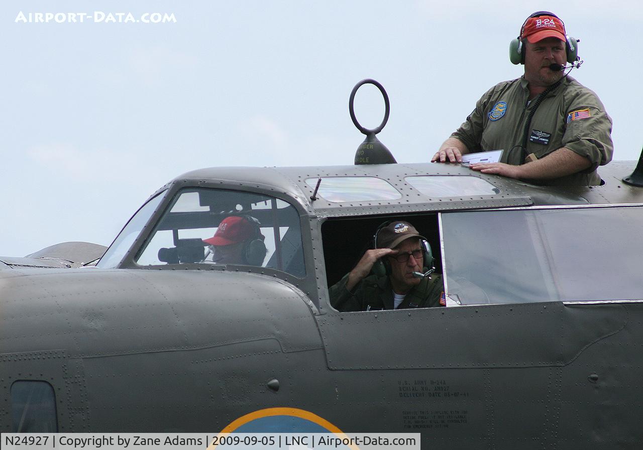 N24927, 1940 Consolidated Vultee RLB30 (B-24) C/N 18, Warbirds on Parade 2009 - at Lancaster Airport, Texas - Pilot saluting and the Flight engineer watching from his hatch in the roof!