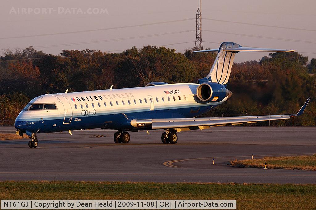 N161GJ, 2006 Bombardier CRJ-550 (CL-600-2C11) C/N 10253, United Express (GoJet Airlines) N161GJ (FLT GJS7373) exitting RWY 5 after arrival from Washington Dulles Int'l (KIAD) late in the day.