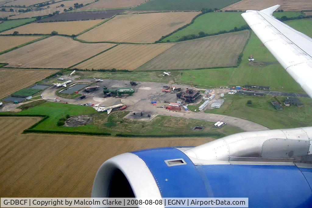 G-DBCF, 2005 Airbus A319-131 C/N 2466, Airbus A319-131 on take-off from Durham Tees Valley showing the fire training area.