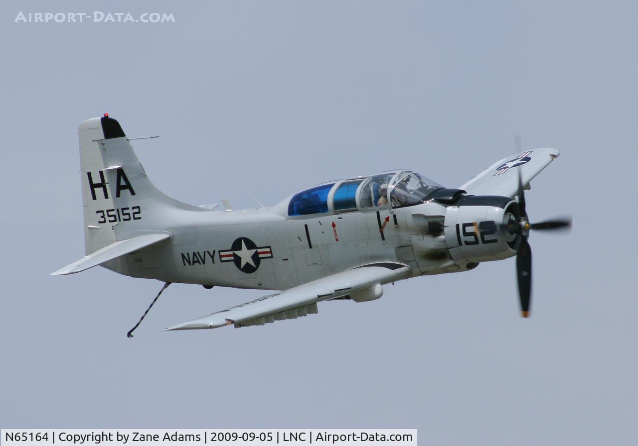 N65164, 1955 Douglas EA-1E Skyraider AD-5W C/N 55-471DH, Warbirds on Parade 2009 - at Lancaster Airport, Texas - Pilot saluting and the Flight engineer watching from his hatch in the roof!
