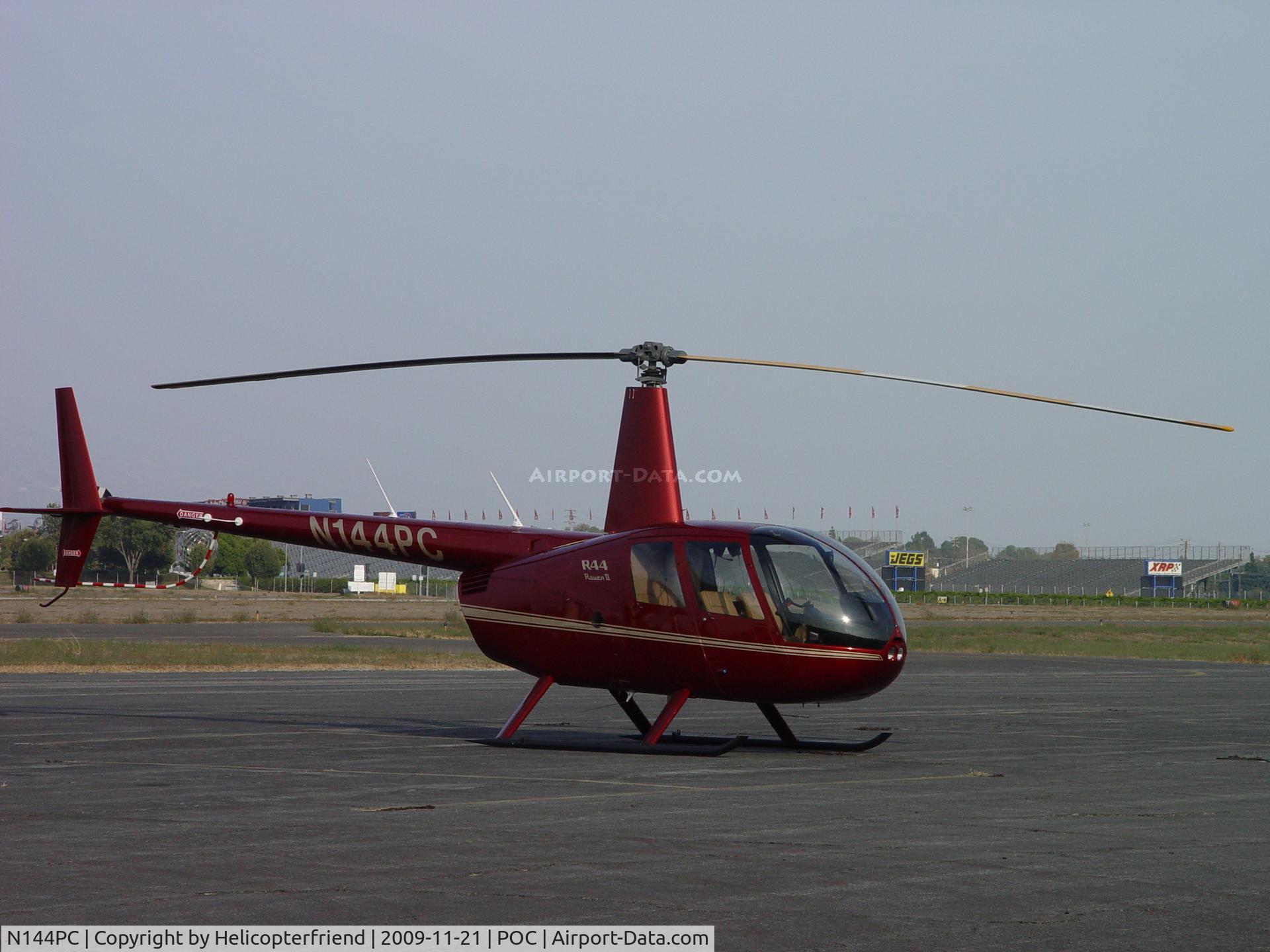 N144PC, 2006 Robinson R44 II C/N 11082, Parked eastside near a Robinson R22