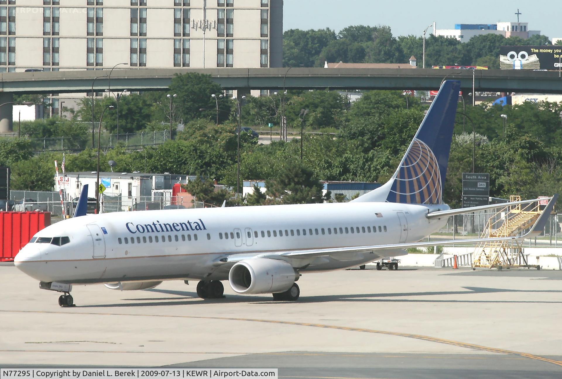 N77295, 2005 Boeing 737-824 C/N 34001, The assorted construction junk in the background contrasts sharply with Continental's brand-new ETOPS-certified 738.