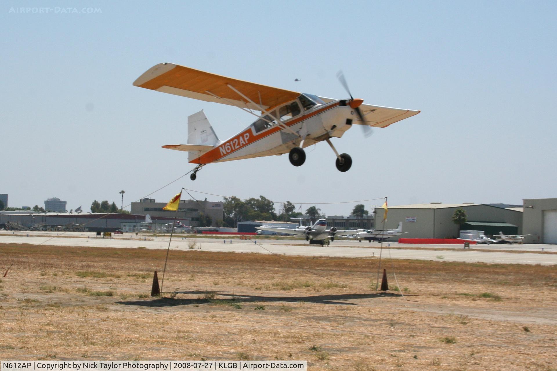 N612AP, 1978 Bellanca 8GCBC C/N 286-78, Picking up a banner. Note the hook inches from the ground