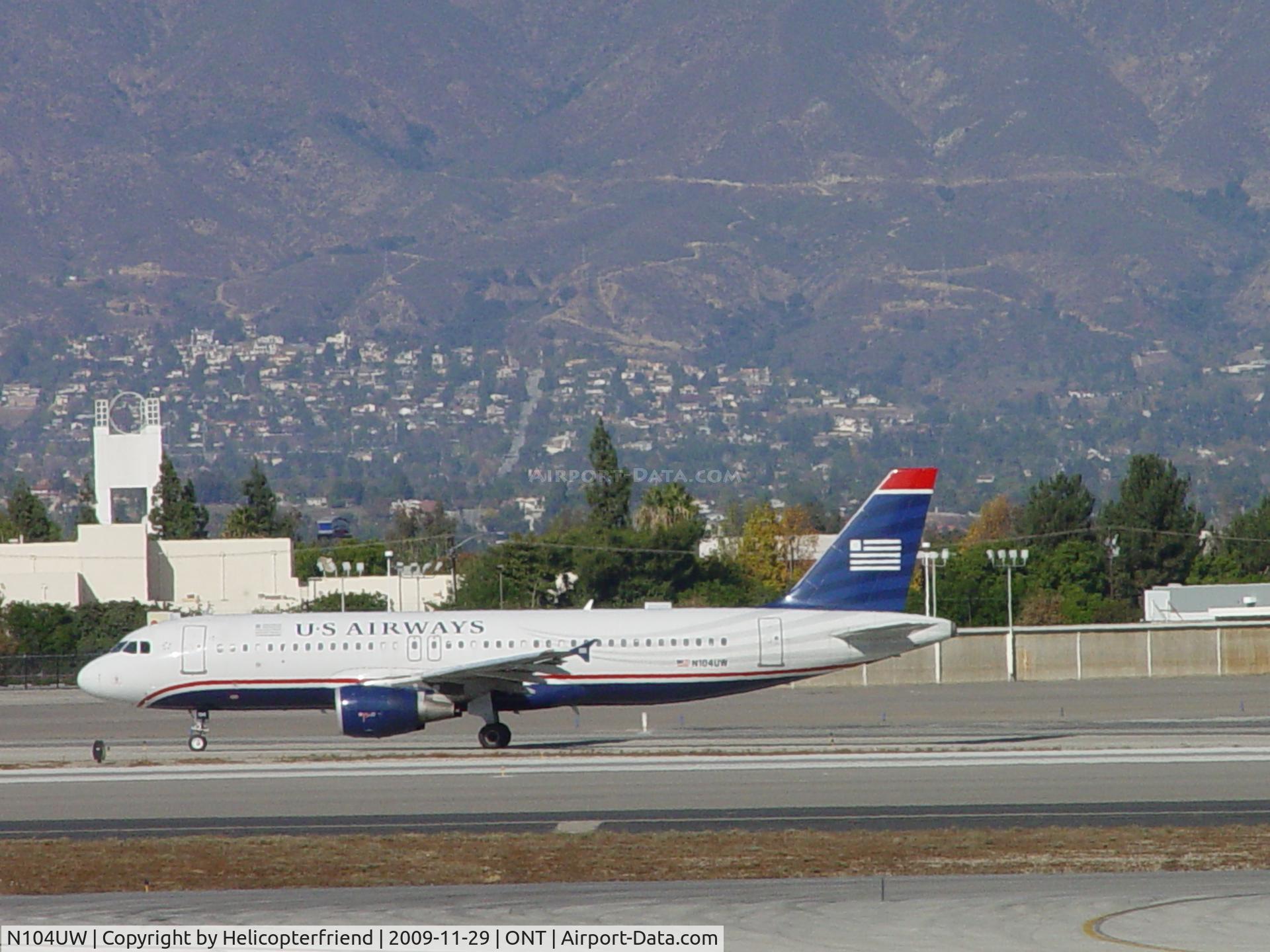 N104UW, 1999 Airbus A320-214 C/N 0863, Taxxing west to runway 8L at Ontario