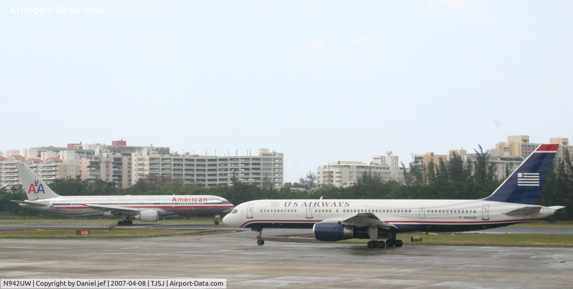 N942UW, 1995 Boeing 757-2B7 C/N 27807, Us airlines taxing to the holding point while american airlines is getting ready for take off