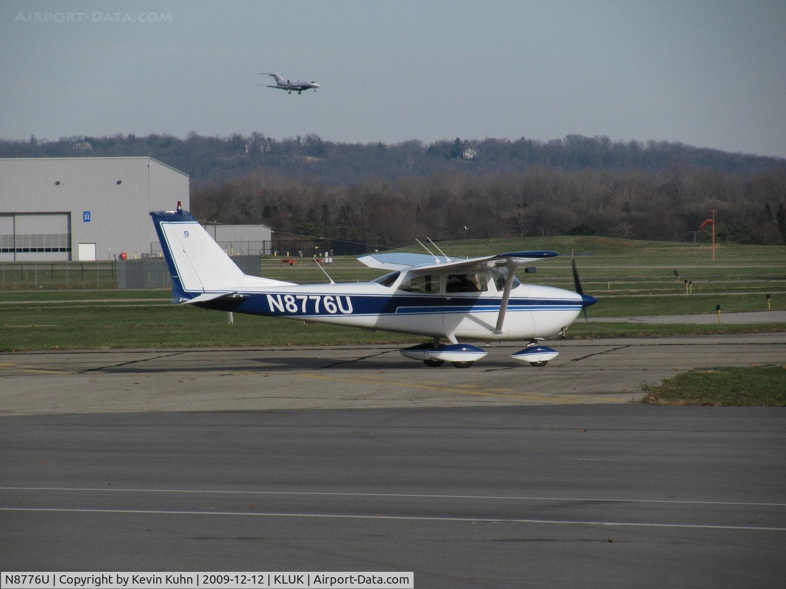 N8776U, 1965 Cessna 172F C/N 17252680, Two Cessna products in one! Citation X N49FW on approach in the background