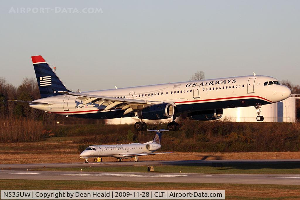 N535UW, 2009 Airbus A321-231 C/N 3993, US Airways N535UW (FLT AWE303) from Denver Int'l (KDEN) landing RWY 18C, with a Continental Express ERJ holding short.