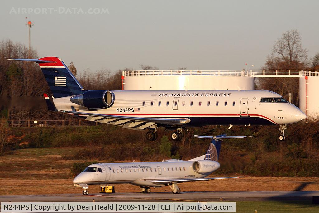 N244PS, 2004 Bombardier CRJ-200ER (CL-600-2B19) C/N 7912, US Airways Express N244PS (FLT JIA392) from Columbia Metropolitan Airport (KCAE) South Carolina landing RWY 18C, while a Continental Express (ExpressJet) ERJ holds short.