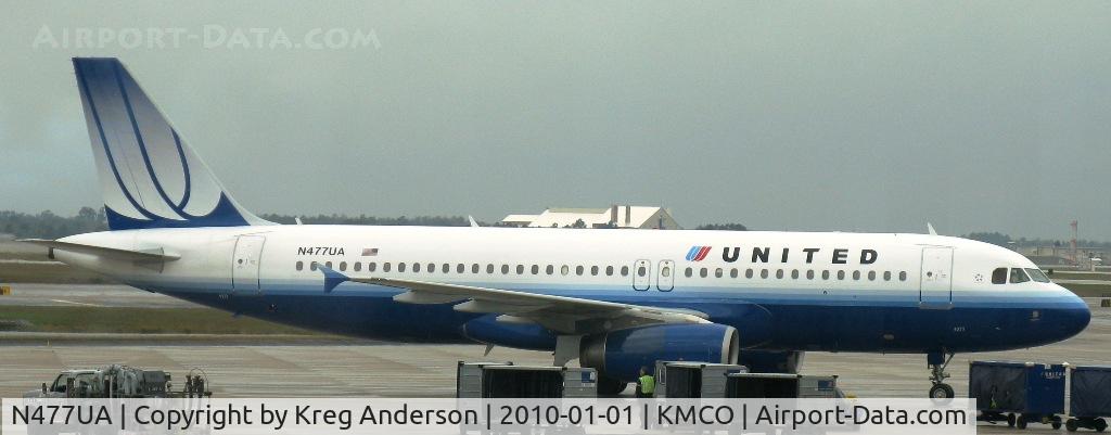 N477UA, 2001 Airbus A320-232 C/N 1514, At the gate at MCO on a rainy New Years.
