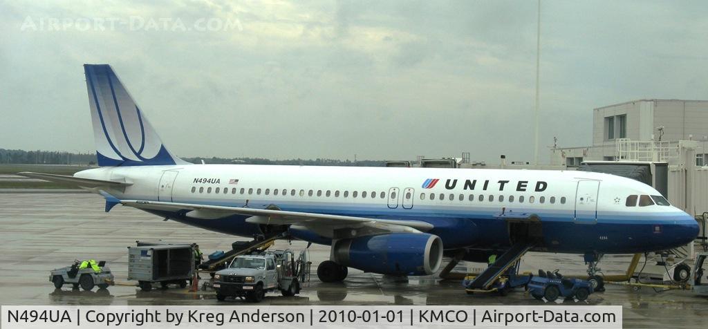 N494UA, 2002 Airbus A320-232 C/N 1840, At the gate at MCO on a rainy New Years.