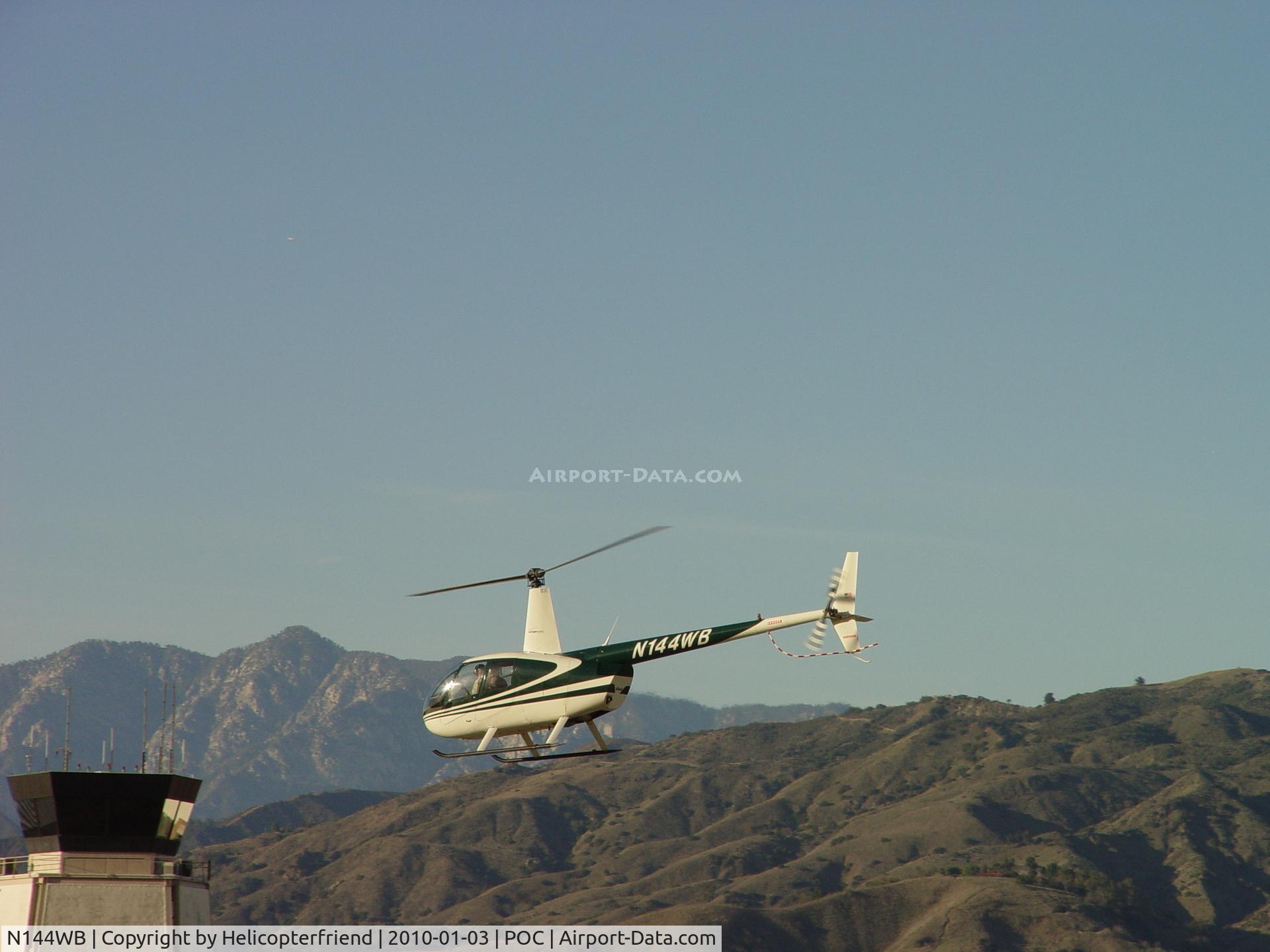 N144WB, 1998 Robinson R44 C/N 0545, Lifting up, proceeding westbound, and getting ready to pass the Tower