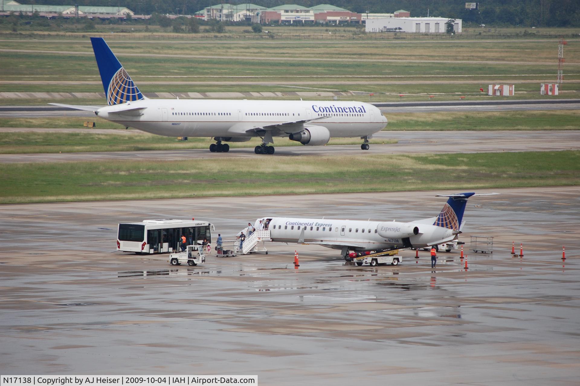 N17138, 2003 Embraer ERJ-145XR (EMB-145XR) C/N 145727, N17138 parked, unloading pax with a COA B764 in the back.